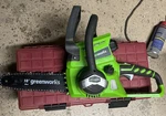 Greenworks 24V Li-ion 10" Cordless Chainsaw, 2.0AH Battery With Charger Used. Price: $35.00.